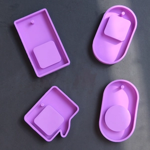 Macro detail of purple silicone molds for DIY pendant tags in rectangle and oval shapes