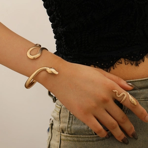 Elegant gold snake jewelry set featuring a detailed wrap bracelet and matching serpent ring
