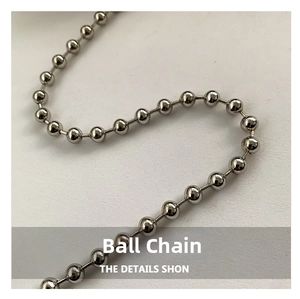 Close-up of a glossy silver beaded chain for handbags showing smooth metal texture