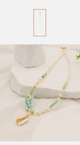 Detailed macro shot of baroque pearl pendant with amazonite and gemstone beads necklace