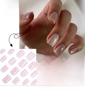 Macro detail of long square pink cat-eye press-on nails with sparkling glitter finish