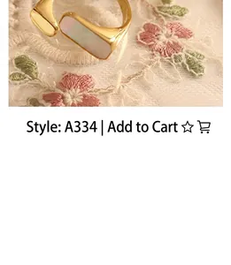 Detailed shot of a gold-plated open ring with an elegant rectangular white shell inlay
