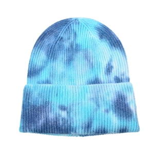 Detail of blue tie-dye knit beanie showing vertical ribbed texture and folded cuff