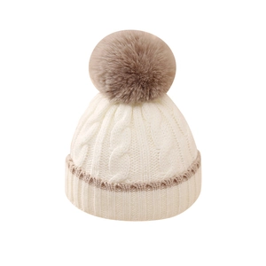 Winter baby knit hat with faux fur pompom in beige and light coffee color tones