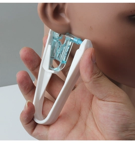 Detailed view of disposable ear piercing gun placement for safe and precise manual use