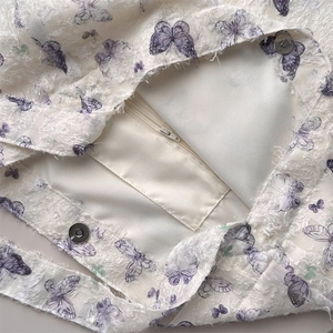 Detailed interior of lace butterfly tote bag showing magnetic buckle and zipper pocket