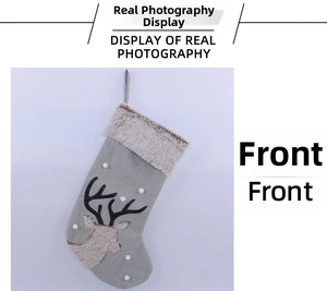 Detail of grey Christmas stocking with plush white reindeer motif and hanging loop