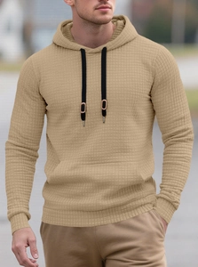Detail of khaki waffle knit hoodie showing black drawstrings and metallic tip accents