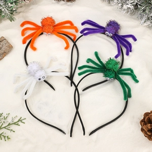 Four colorful Halloween spider headbands with sequins on a decorative winter background