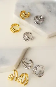Close-up of triple-layered S925 silver ear cuffs in gold and silver finishes