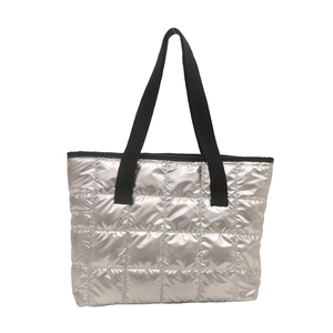 Silver quilted tote bag with black straps and shiny puffer texture on white background