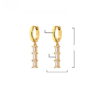 Detail view of gold brass drop earrings with triple AAA+ rectangular zircon stones