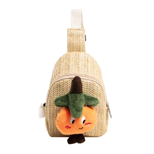 Handwoven straw crossbody bag for kids featuring a cute orange plush fruit decoration