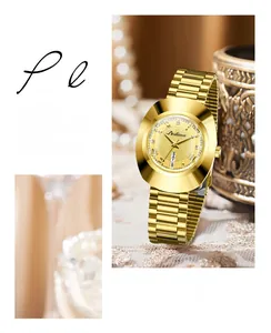 Detail of Dedima gold watch featuring rhinestone indices and dual calendar display window
