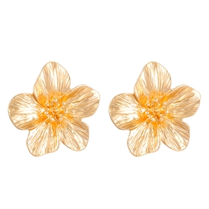 Close-up of golden flower earrings with crinkled texture and metallic finish