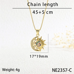 Detail view of gold sun and moon pendant with colored zircon inlay and size parameters