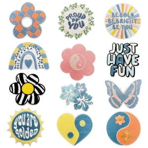 Set of 12 colorful embroidered patches featuring animal paws and uplifting floral patterns