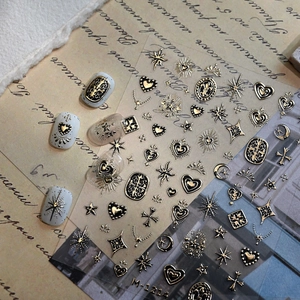 Gothic 3D embossed nail stickers with gold hearts and stars on vintage paper background