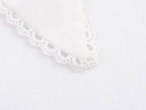 Close-up of elegant white shirt collar featuring delicate hollow lace edges and fine texture