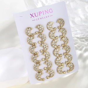 Detail of six pairs of gold-plated crescent moon and star earrings with zircon inlay