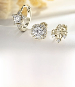 Macro shot of coffee gold star ear cuff and square zircon stud with size details