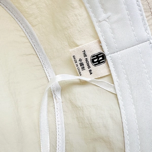 Quick-dry breathable bucket hat detail showing premium interior label and fabric texture