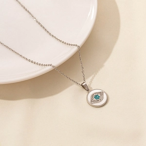 Detail of evil eye pendant with blue crystal and cubic zirconia on a silver chain