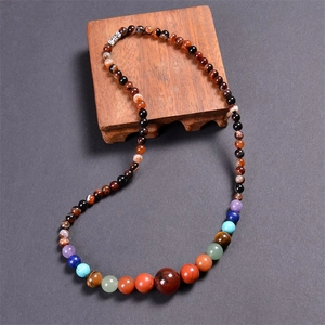 Macro detail of multicolored gemstone beads on a premium wooden display stand