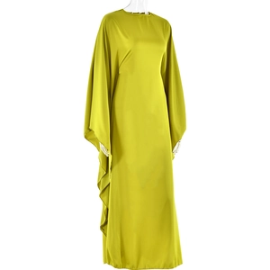 Detail view of smooth yellow-green satin fabric and batwing sleeves on a long dress