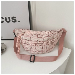 Close-up of pink woven plaid crossbody bag with nylon strap and adjustable buckle