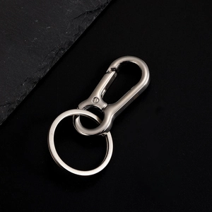 Industrial stainless steel car keychain with spring horseshoe clip on black background