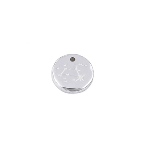 Macro view of silver stainless steel circular pendant with engraved zodiac sign detail