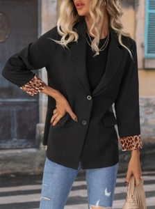 Detail of leopard print lining on the cuffs of a black casual blazer for women