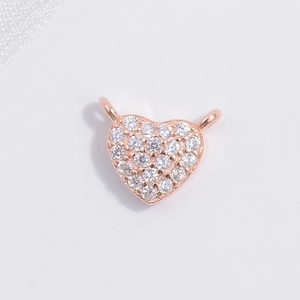 Detail of rose gold heart charm with pavé cubic zirconia and hanging connector loops