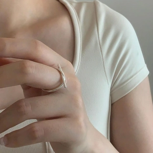 Minimalist S925 sterling silver knotted line ring shown on finger with soft lighting