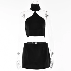 Women's sexy black halter crop top and mini skirt set shown on a female mannequin