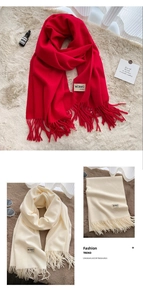 Detail view showing soft red and beige pashmina scarves for winter warmth and styling