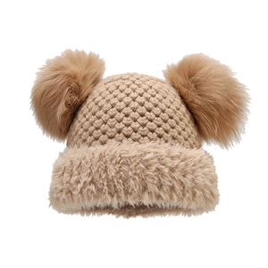 Winter knitted beanie for women featuring dual faux fur pom-poms and warm plush trim
