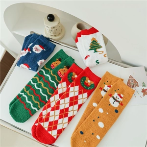 Detailed display of five pairs of warm Christmas coral fleece socks with festive patterns
