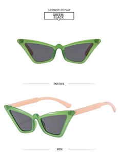 Detail view of green cat eye sunglasses with black lenses and orange temples