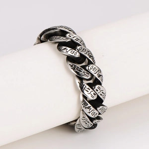 Vintage stainless steel Cuban link bracelet with engraved religious totem patterns