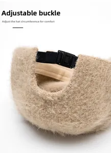 Close-up of beige plush baseball cap featuring adjustable black strap and plastic buckle