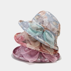 Three stacked floral sun hats with elegant organza bows for outdoor sun protection
