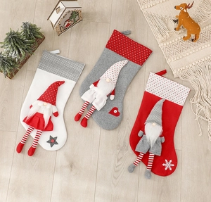 Three Nordic gnome Christmas stockings in white, grey, and red with 3D plush gnome detail