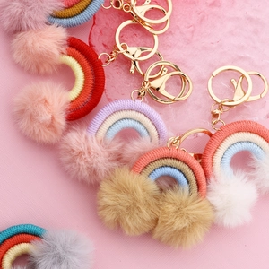 Handmade woven rainbow keychain charms with plush pom poms and gold metal lobster clasps