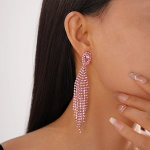 Detailed view of pink rhinestone long tassel earrings showing elegant drape on a model