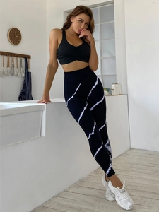 Detail of high-waist yoga leggings featuring white tie-dye print and ribbed texture