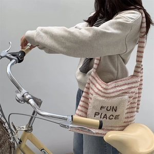 Detailed close-up of winter fuzzy striped tote bag with FUN PLACE embroidery detail