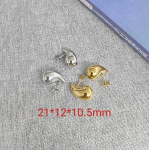 Macro shot of silver and gold teardrop earrings with precise 21x12x10.5mm dimensions