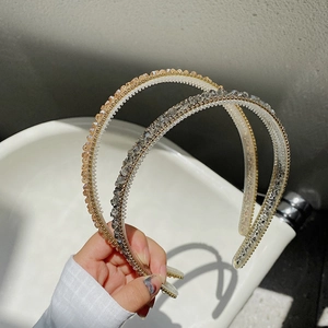 Detail of slim crystal headband featuring non-slip inner teeth and sparkling stones